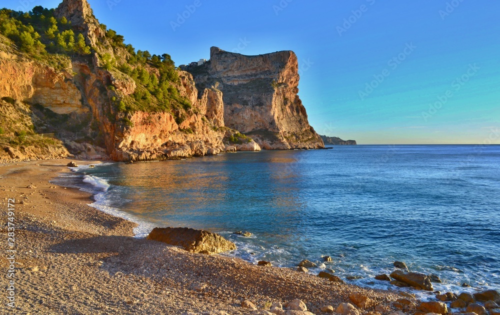 Beautiful beach in Spain with steep cliffs.
