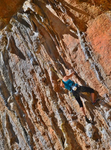 Young girl is climbing one of the routes in Geyikbayiri, Turkey. 