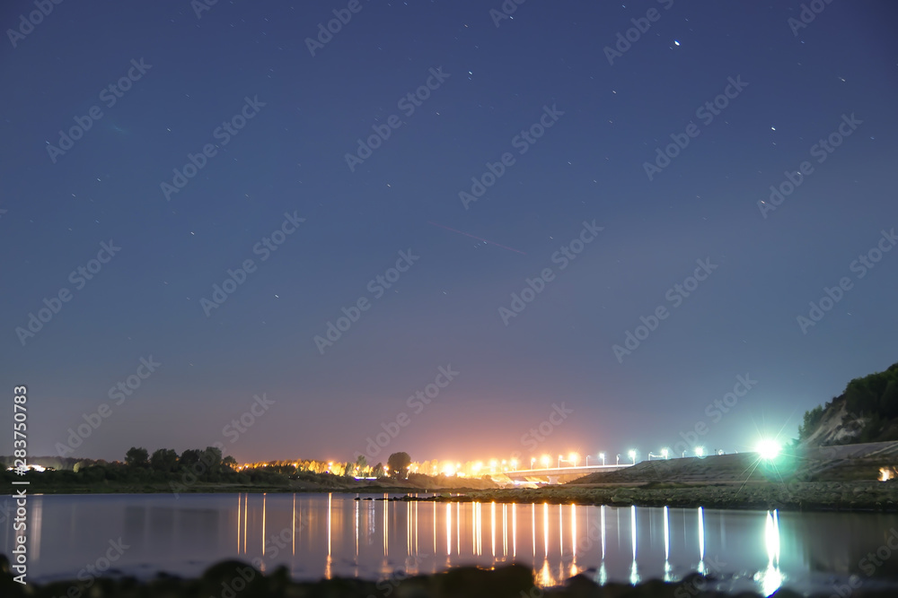 bridge on the river at night under a starry sky bridge on the river at night under a starry sky