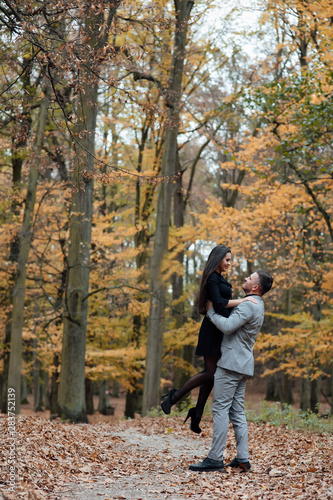 Happy young couple in love. The guy holding his girlfriend in his arms. Romantic relationship in autumn forest. Love story. To love each other. © Tetiana Moish