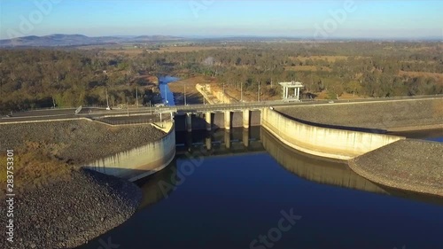 Aerial orbit shot of Wivenhoe Dam, with the stunning Brisbane Valley in the background, on a clear winter's morning photo