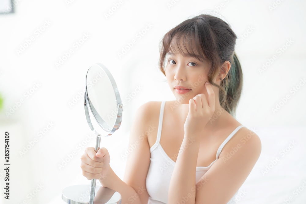 Beautiful face young asian woman with happy smiling and looking mirror, makeup of beauty facial girl with skincare and cosmetic treatment, refresh of female and clean for charming, healthy concept. Beautiful face young asian woman with happy smiling and looking mirror, makeup of beauty facial girl with skincare and cosmetic treatment, refresh of female and clean for charming, healthy concept.