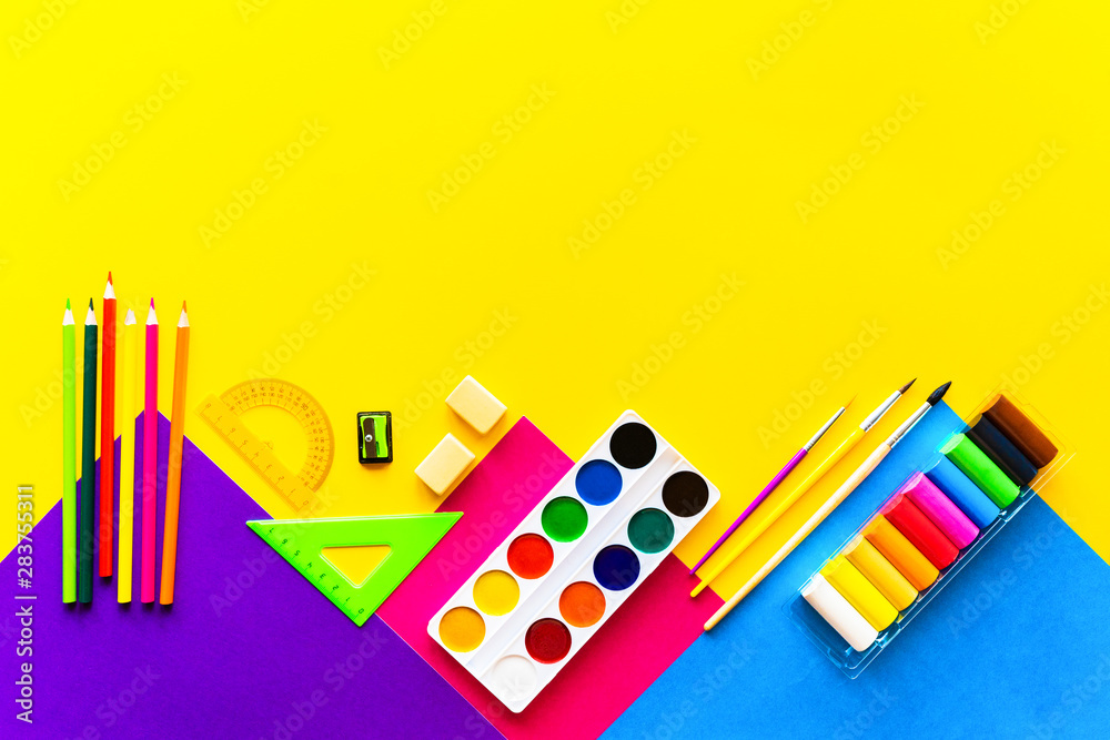 Fototapeta premium School bright supplies on a yellow background.