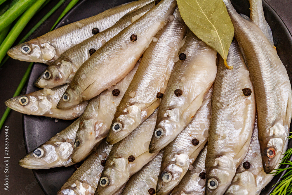 Fototapeta premium Fresh raw sea fish smelt or sardines ready for cooking