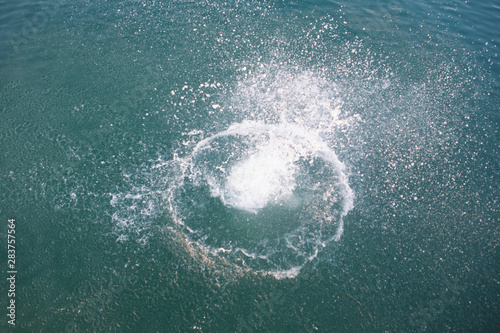 big splash in lake water view from above