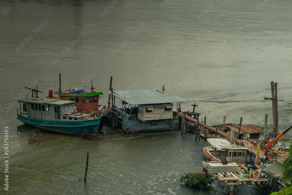 Many boats docked in the Chao Phraya River in the afternoon.