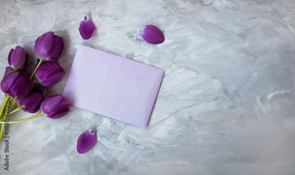 Top view background of bouquet of tulips and a letter Top view background of bouquet of tulips and a letter