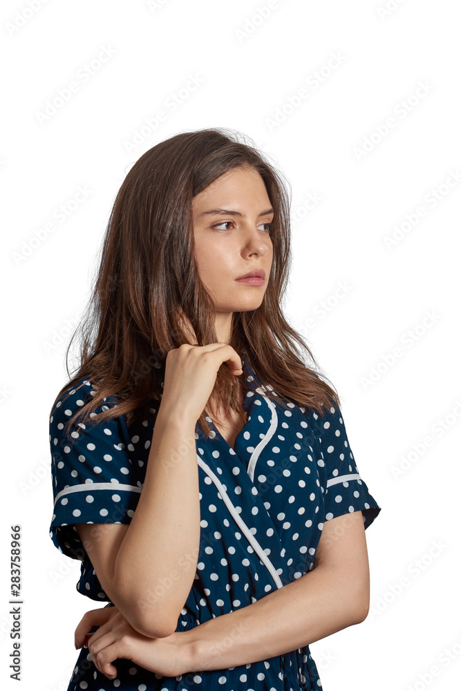 Young girl with dot dress looking suspiciously Young girl with dot dress looking suspiciously