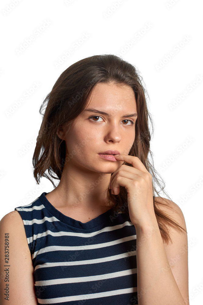 Young girl holding her finger in mouth and looking at the camera Young girl holding her finger in mouth and looking at the camera