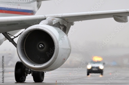 Airplane plane engine and car airport escort vehicle. Follow me car with yellow flasher
