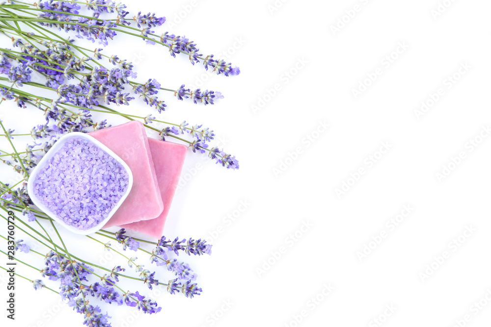 Lavender flowers with spa salt and soap on white background Lavender flowers with spa salt and soap on white background