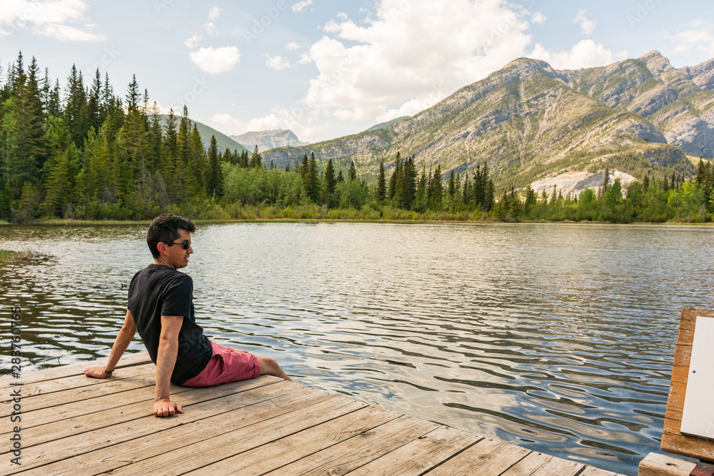 Man enjoying a beautiful view by a lake in the mountains