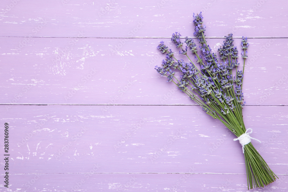 Fototapeta premium Lavender flowers on purple wooden table