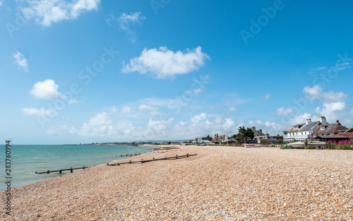 Fototapeta Naklejka Na Ścianę i Meble -  Pevensey Bay Beach, East Sussex, England. A summer view of the pebble beach at Pevensey Bay on the south coast of England near Eastbourne.