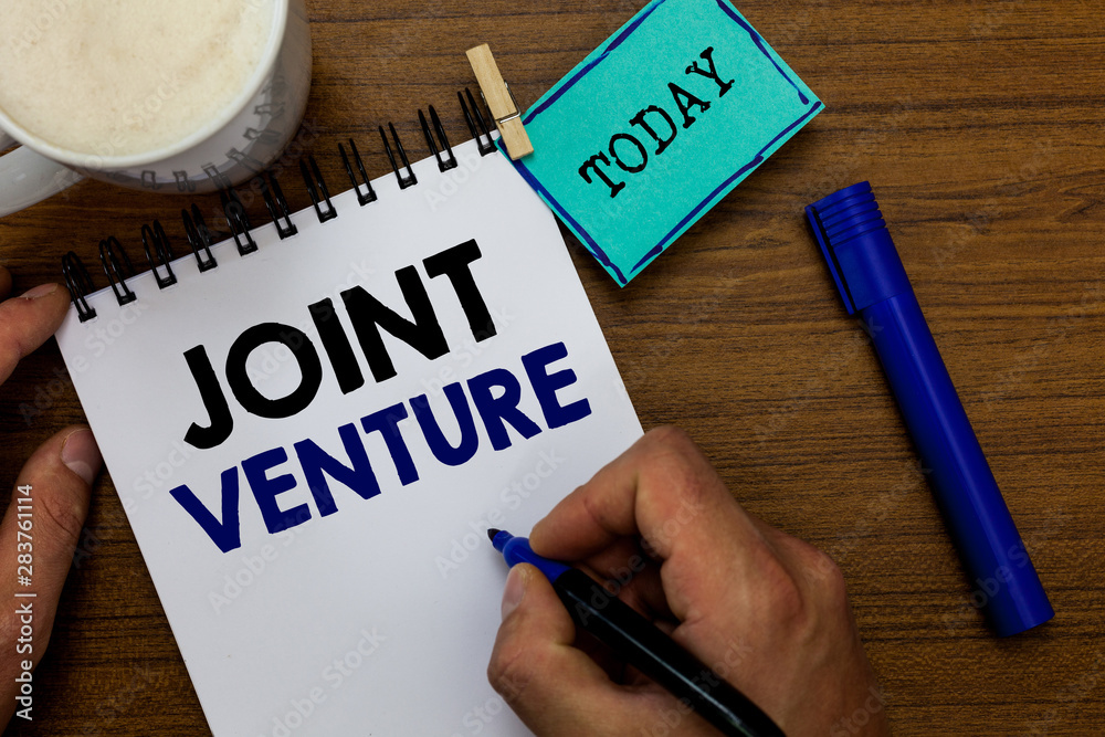 Writing note showing Joint Venture. Business photo showcasing Collaboration Arrangement Parties Partnership Team Man holding marker notebook clothespin reminder wooden table coffee Writing note showing Joint Venture. Business photo showcasing Collaboration Arrangement Parties Partnership Team Man holding marker notebook clothespin reminder wooden table coffee