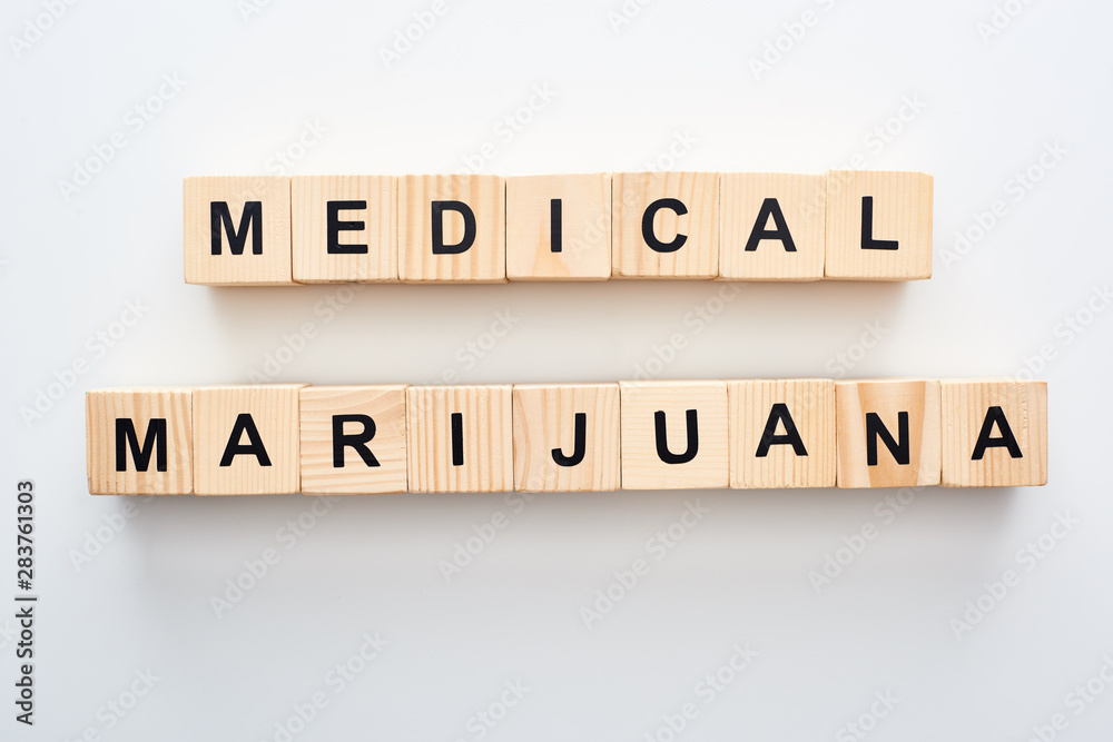 top view of wooden blocks with medical marijuana words on white background top view of wooden blocks with medical marijuana words on white background