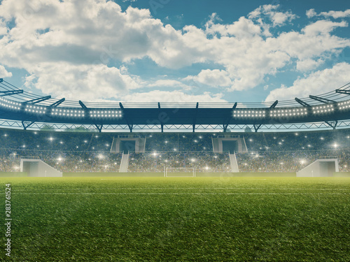 Soccer stadium with tribunes, cheering fans, blue cloudy sky and green grass.  photo