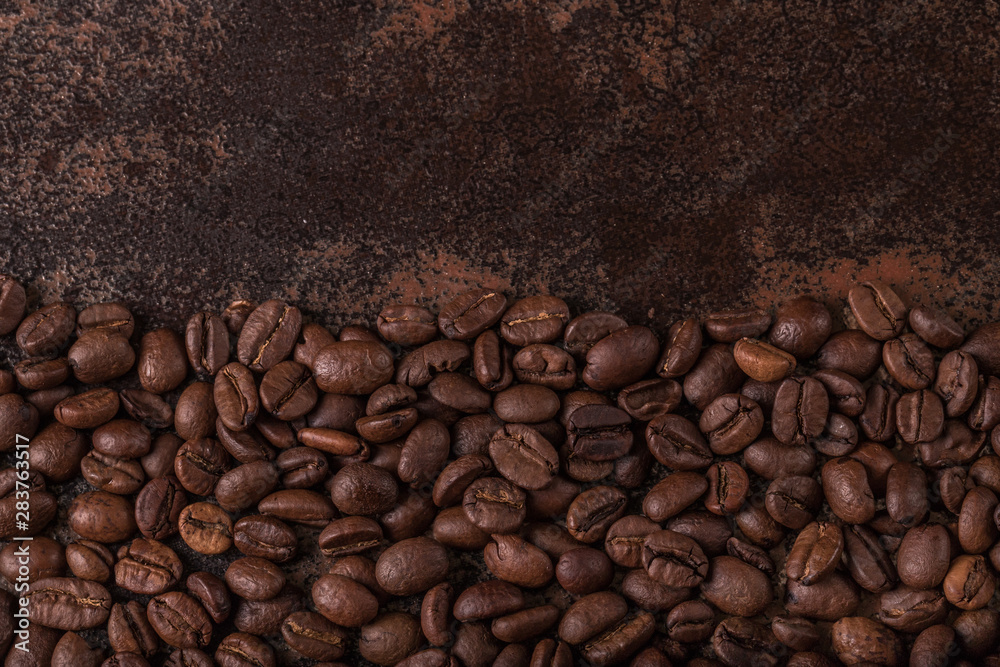 Coffee beans on stone background. Top view with copy space for your text. Roasted coffee beans background. Beans texture, macro Coffee beans on stone background. Top view with copy space for your text. Roasted coffee beans background. Beans texture, macro