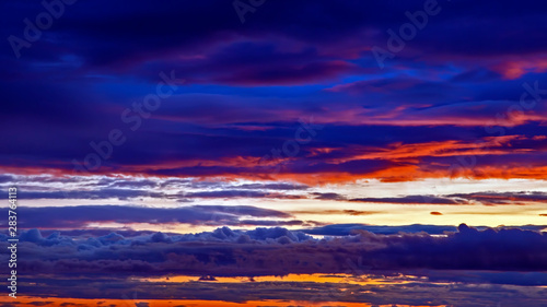 Unrealistic colorful sunset in the lush clouds in Iceland