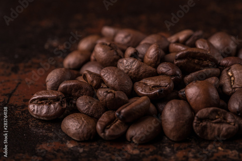 Coffee beans on stone background. Top view with copy space for your text. Roasted coffee beans background. Beans texture, macro