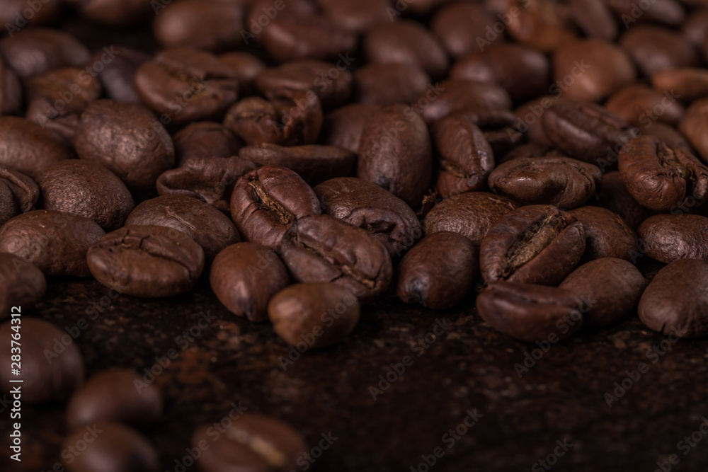 Coffee beans on stone background. Top view with copy space for your text. Roasted coffee beans background. Beans texture, macro Coffee beans on stone background. Top view with copy space for your text. Roasted coffee beans background. Beans texture, macro