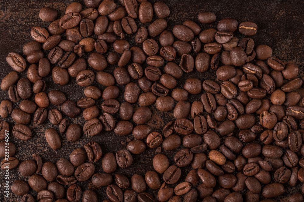 Coffee beans on stone background. Top view with copy space for your text. Roasted coffee beans background. Beans texture, macro Coffee beans on stone background. Top view with copy space for your text. Roasted coffee beans background. Beans texture, macro