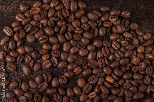 Coffee beans on stone background. Top view with copy space for your text. Roasted coffee beans background. Beans texture, macro