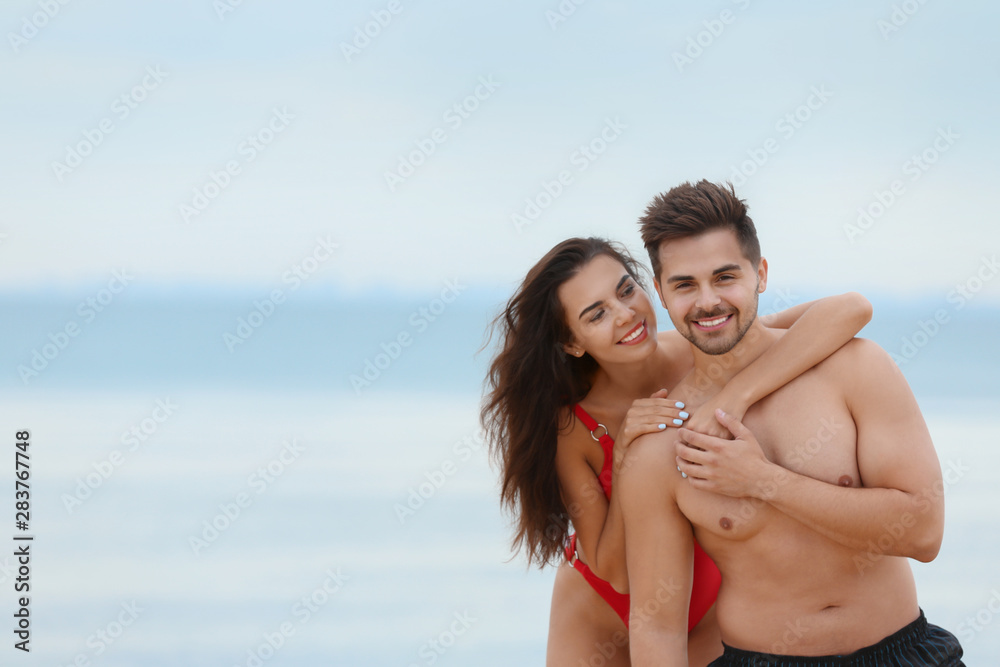 Happy young couple spending time together on beach