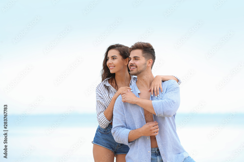 Happy young couple spending time together on beach Happy young couple spending time together on beach