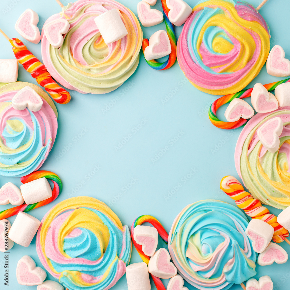 Frame made with tasty sugar candies on color background, top view. Space for text, party, candy bar, childhood, birthday concept Frame made with tasty sugar candies on color background, top view. Space for text, party, candy bar, childhood, birthday concept
