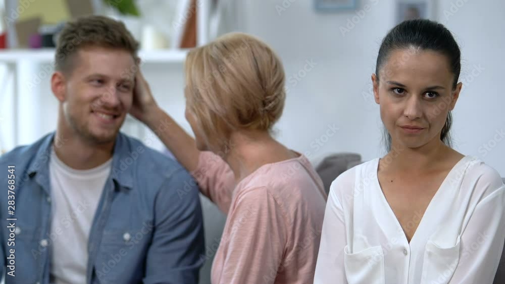 Annoyed wife suffering attention lack during husband talking with mother problem Annoyed wife suffering attention lack during husband talking with mother problem