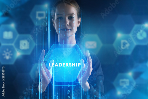 The concept of business, technology, the Internet and the network. A young entrepreneur working on a virtual screen of the future and sees the inscription: Leadership