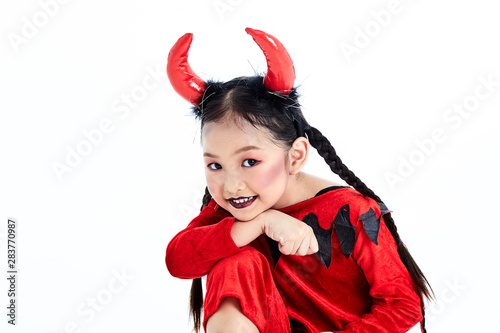 girl in a halloween fancy dress devil