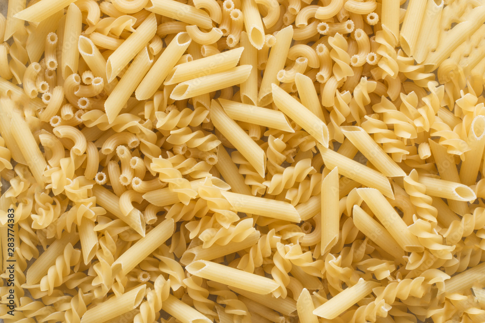 Background of pasta of various kinds top view. Many different sorts of pasta, italian cuisine concept. Background of pasta of various kinds top view. Many different sorts of pasta, italian cuisine concept.