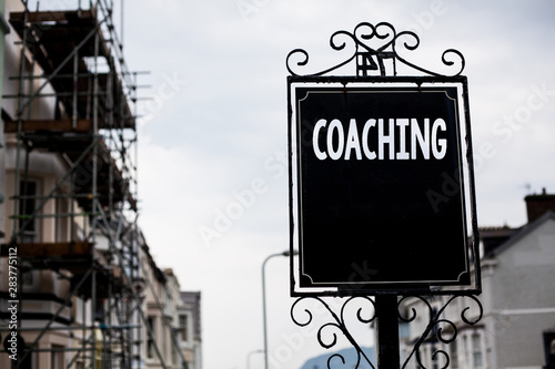Writing note showing Coaching. Business photo showcasing Prepare Enlightened Cultivate Sharpening Encourage Strenghten Vintage black board sky old city ideas scaffolding landscapes antique