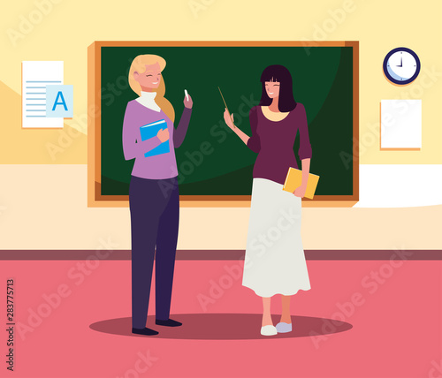 female teachers couple with in the classroom © djvstock