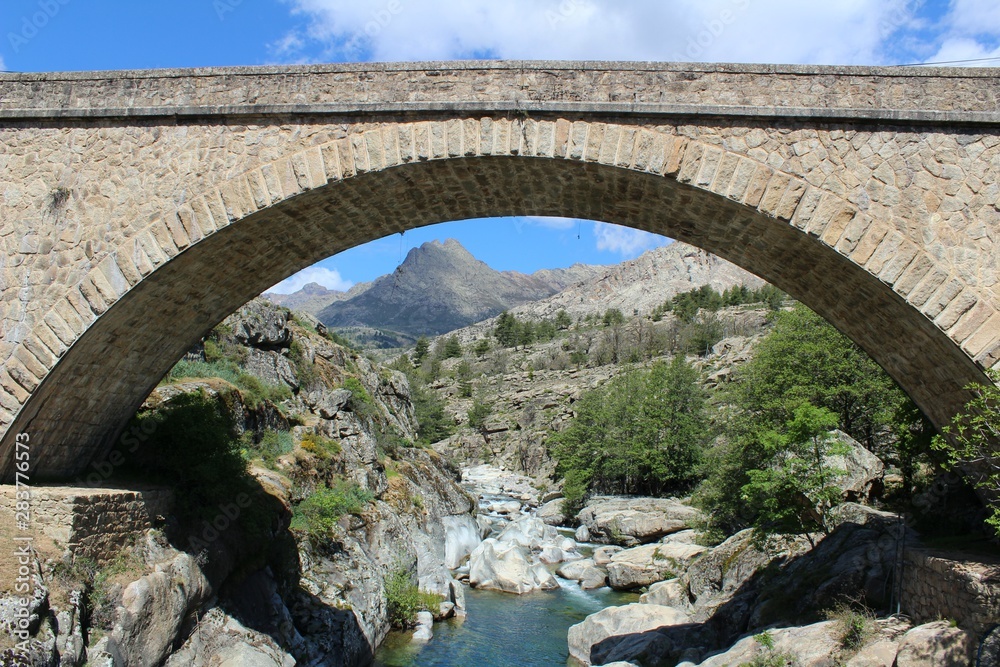 Monte Cinto View and an Old Bridge over Golo River near Albertacce in Corsica