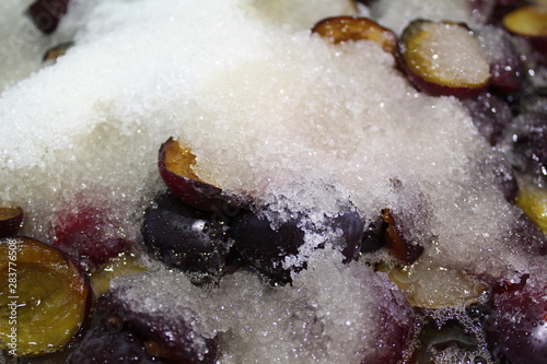 Fototapeta Naklejka Na Ścianę i Meble -  halves of plums pitted with sugar