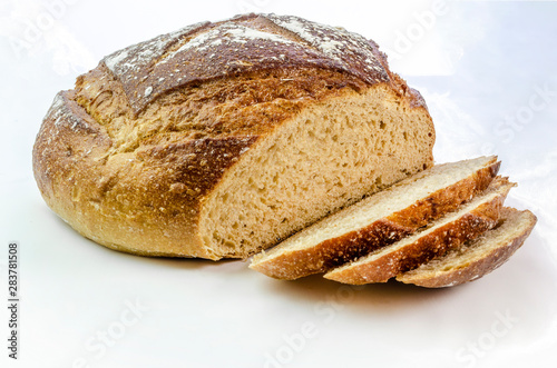 Dark rye bread with three slices on a white isolated background. 