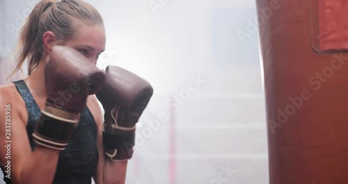 Female exercising with a a punch bag photo