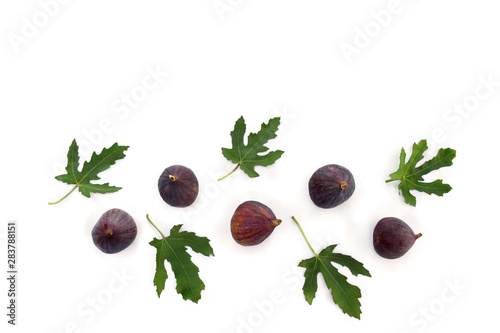 Figs with green leaves on white background with space for text. Top view, flat lay