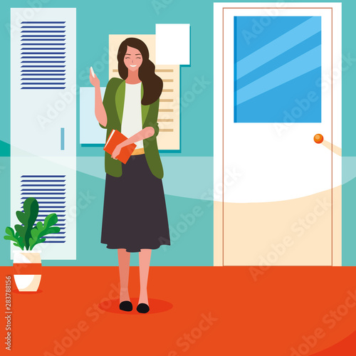 female teacher with textbook in corridor school
