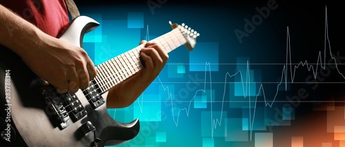 Male Guitarist playing music on background