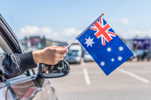 Boy holding of Australia from the open car window on the parking of the shopping mall. Concept