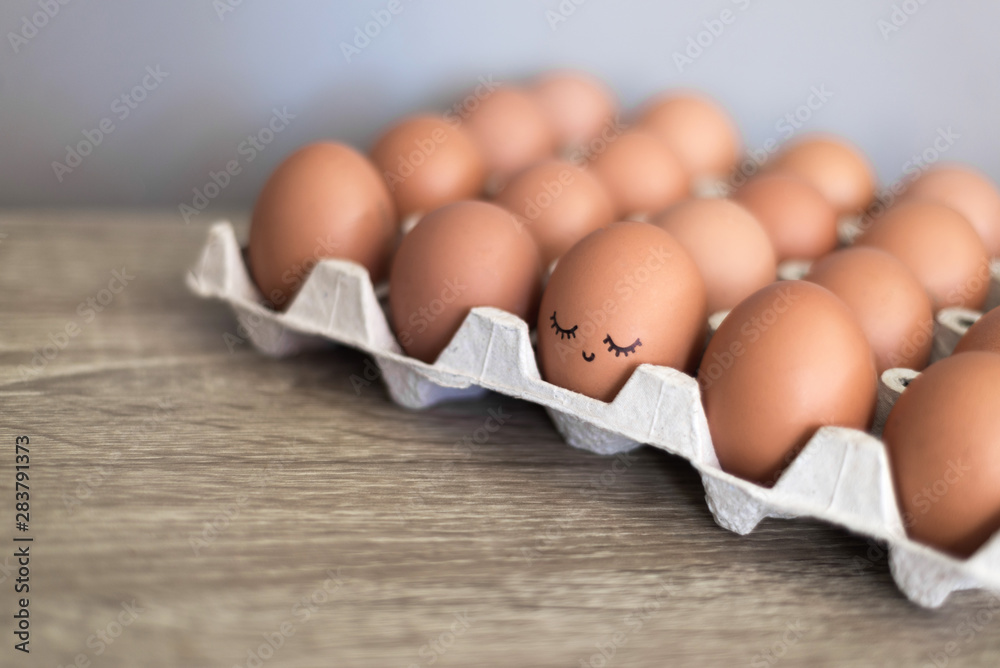 Egg with happy face in the basket with other eggs. Egg with happy face in the basket with other eggs.