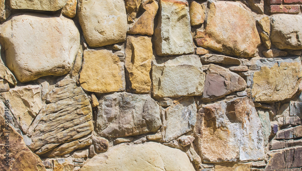 Background of masonry. Wall of different types of stone_