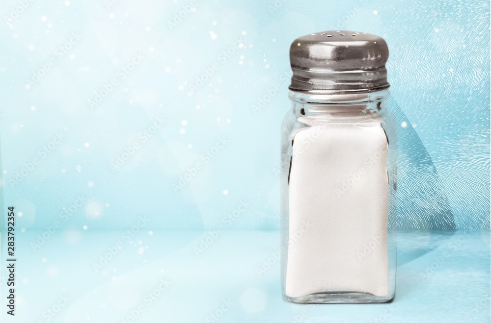 Salt in straw on blue background and highlights