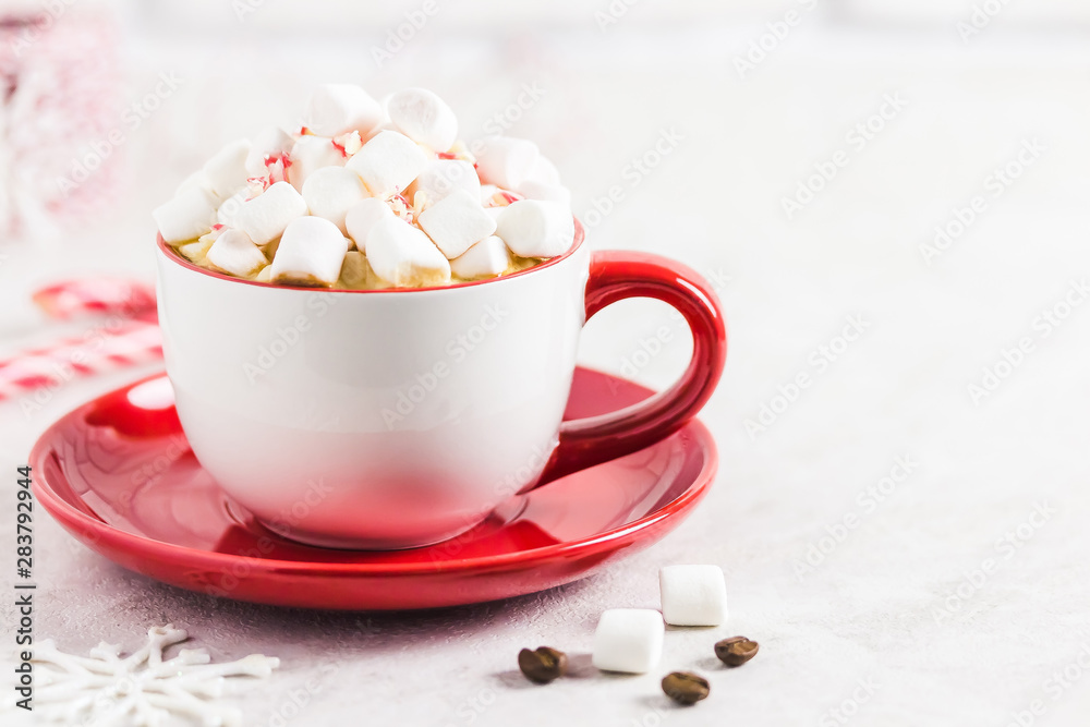Chrismas marshmellow peppermint coffee in red cup on white marble background. Selective focus, space for text. Chrismas marshmellow peppermint coffee in red cup on white marble background. Selective focus, space for text.
