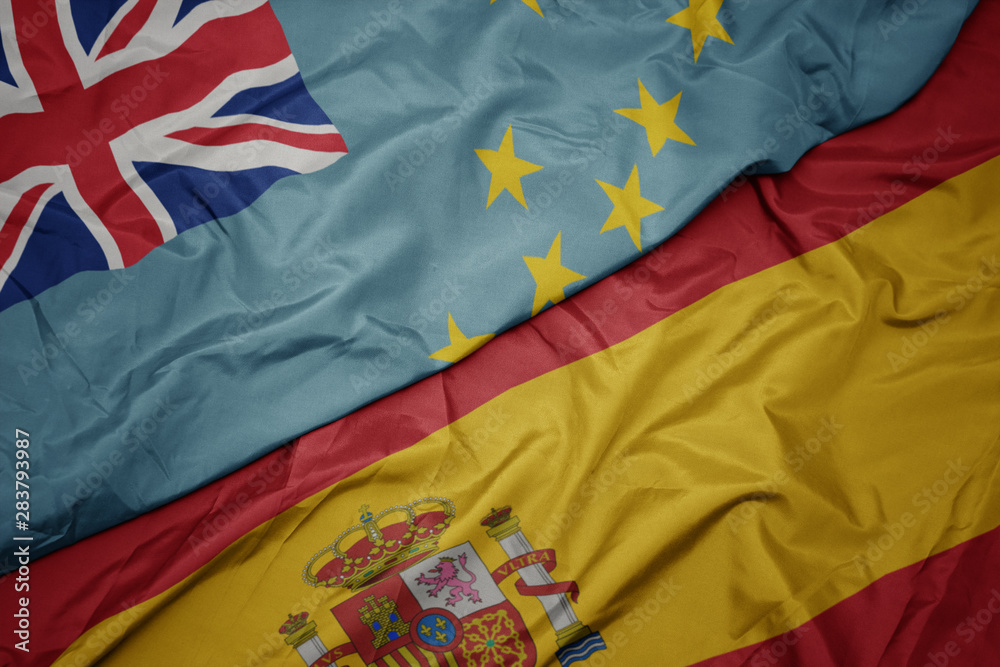 waving colorful flag of spain and national flag of Tuvalu . waving colorful flag of spain and national flag of Tuvalu .