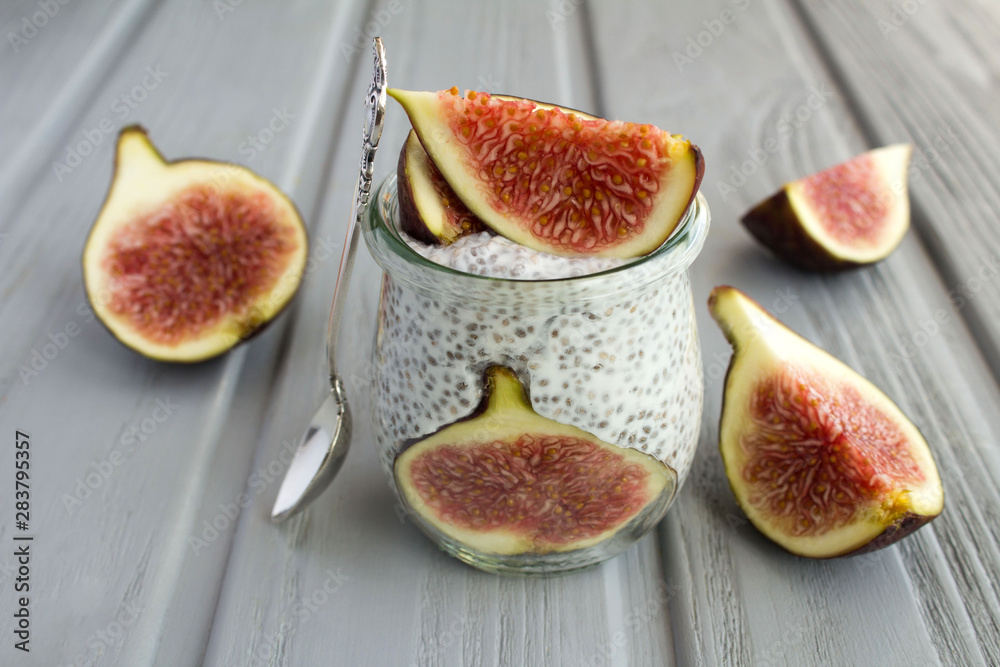 Pudding with chia and figs on the grey wooden background. Closeup. Pudding with chia and figs on the grey wooden background. Closeup.